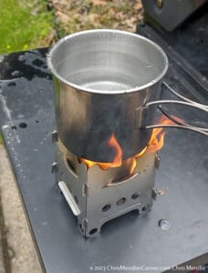 Boiling water using a mini stove and a rutland fire starter. 